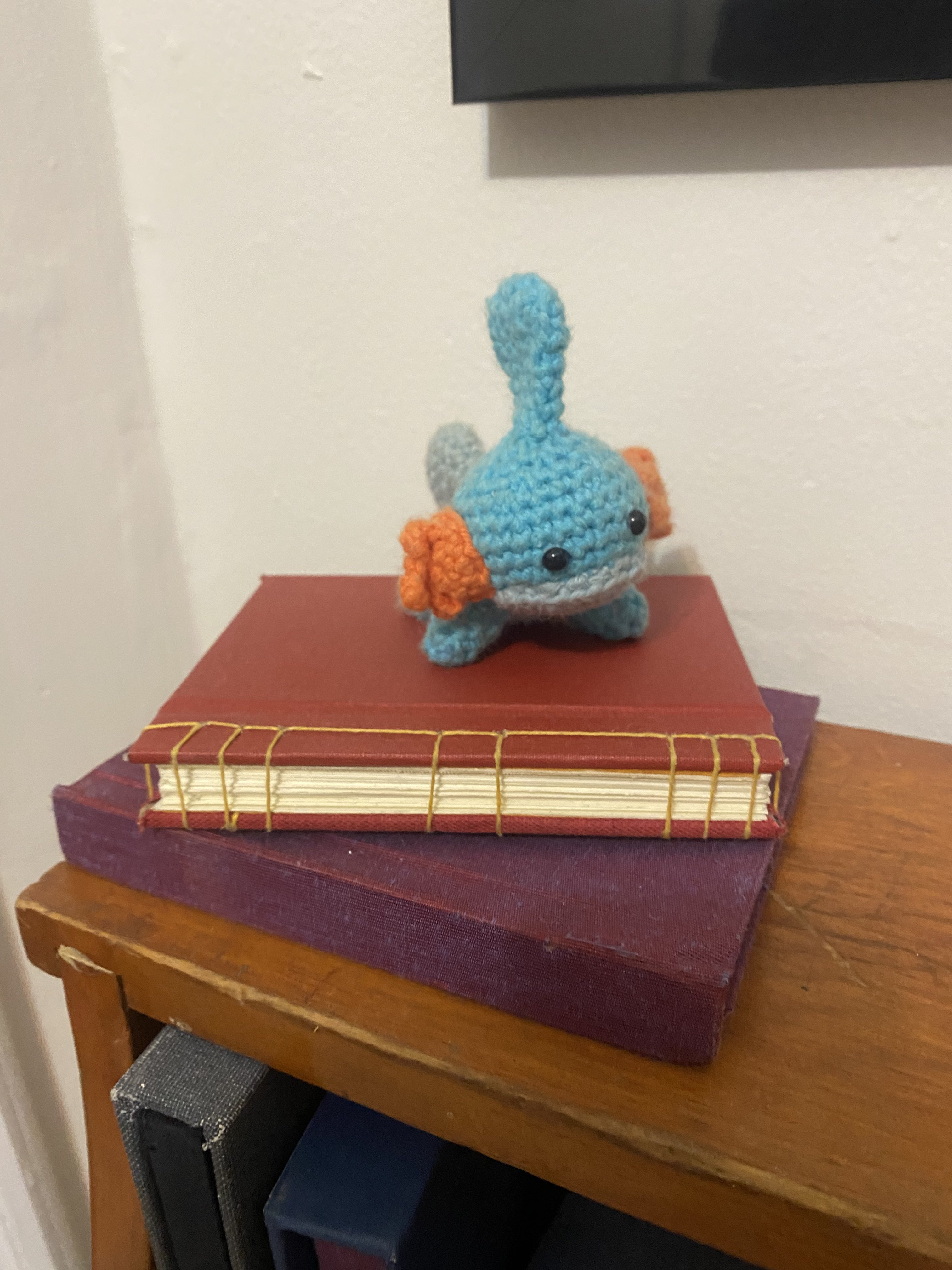 Two stacked books and a crochet stuffed toy