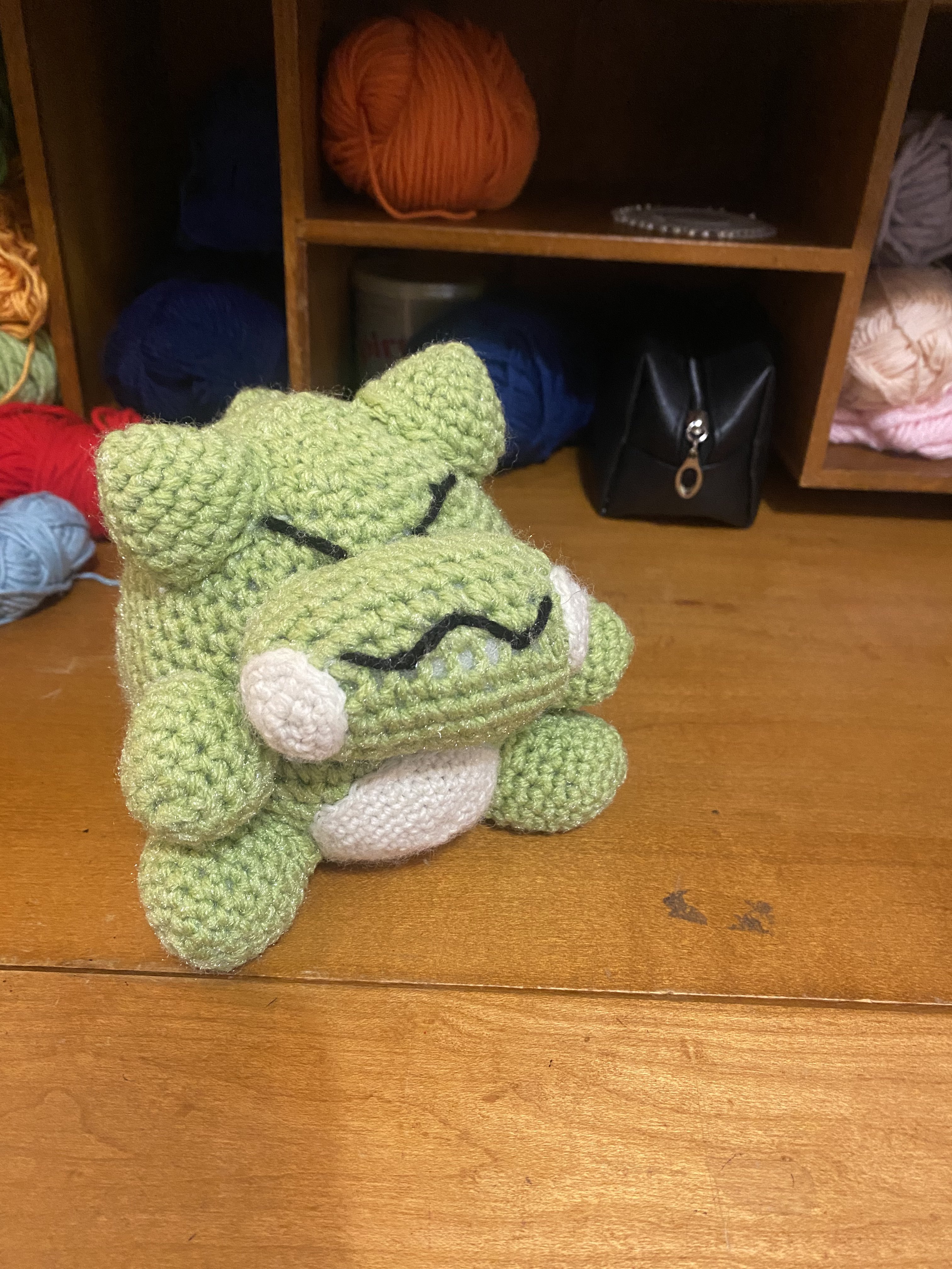 A reptile-like crochet stuffed toy