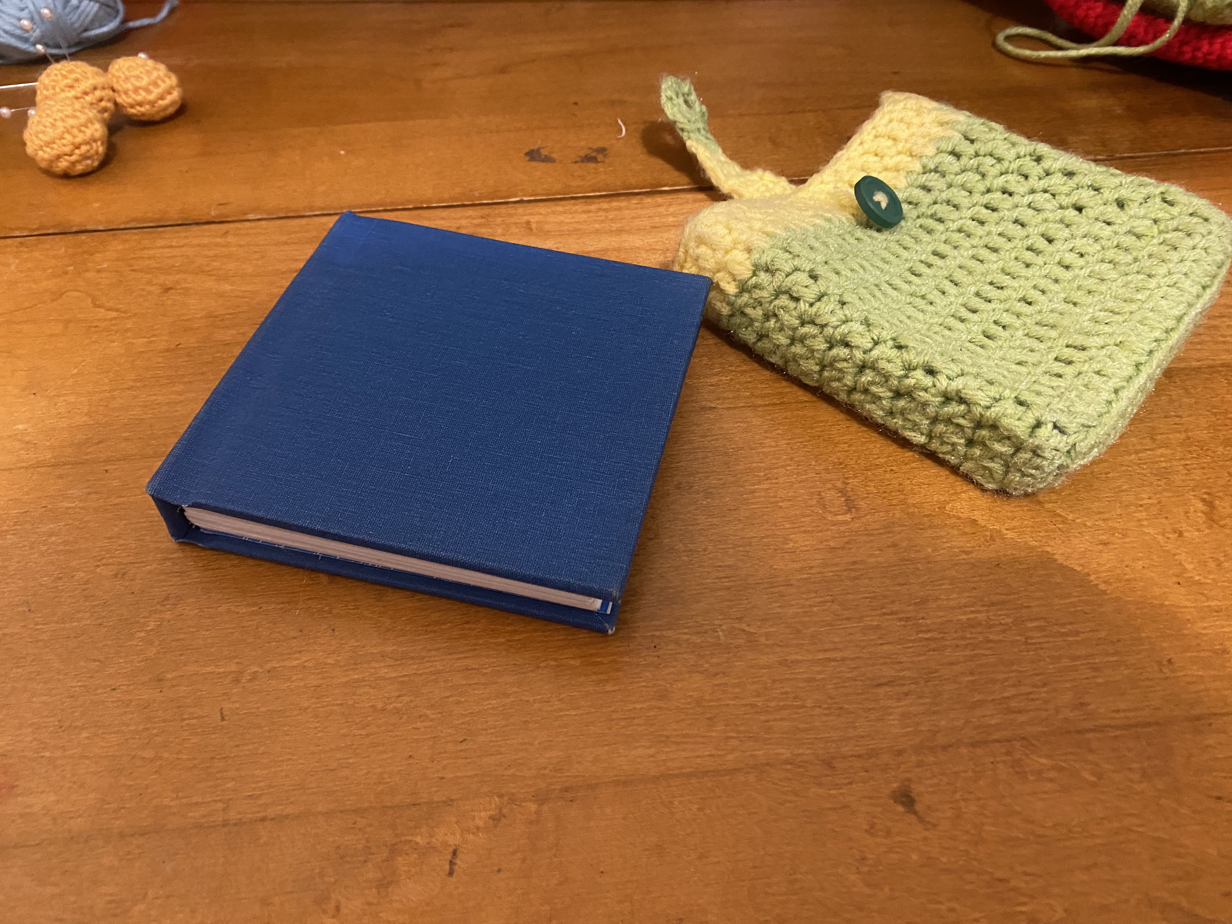 A hard cover book next to a crochet cover