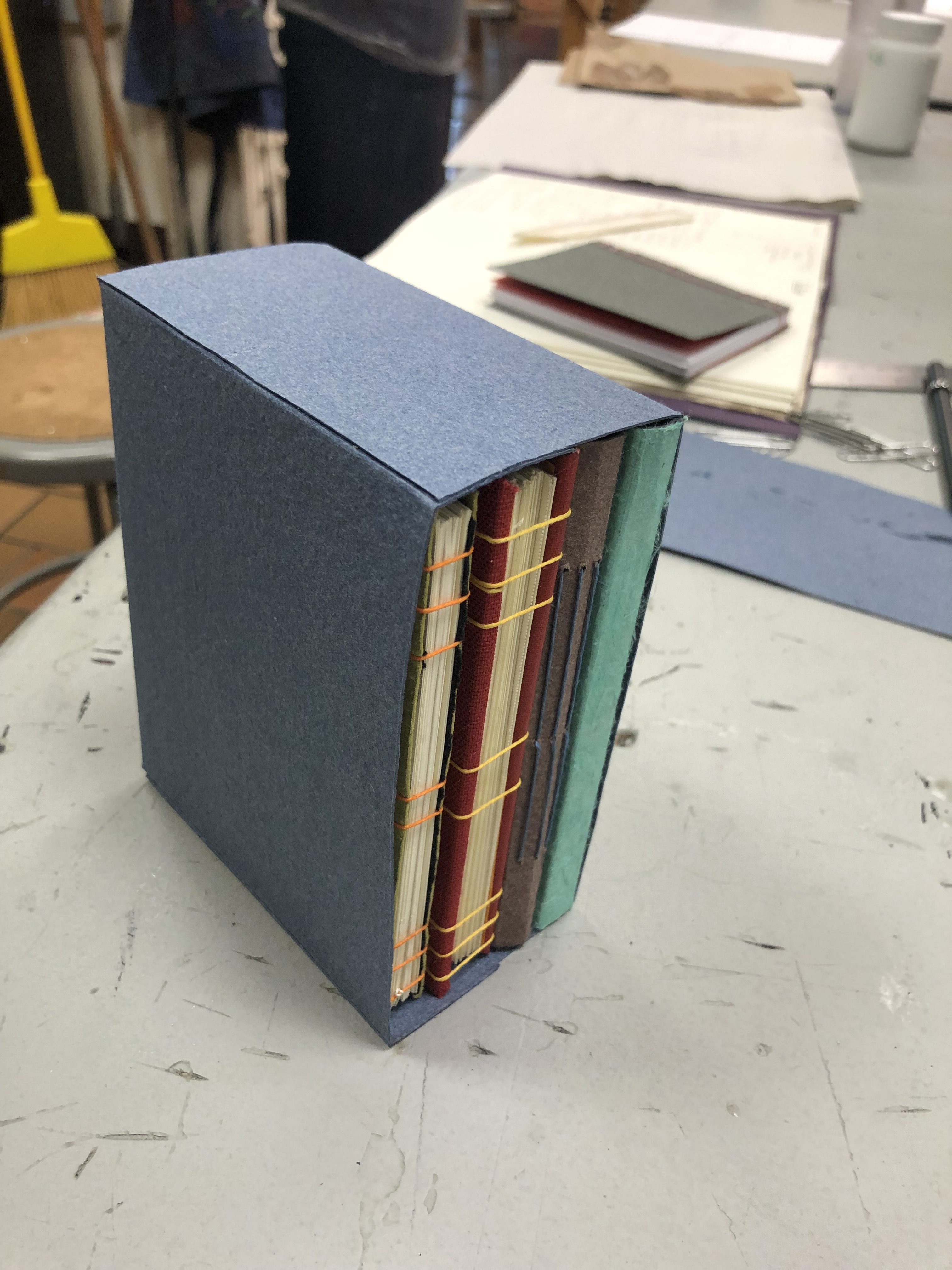 A handmade paper case for books with books inside